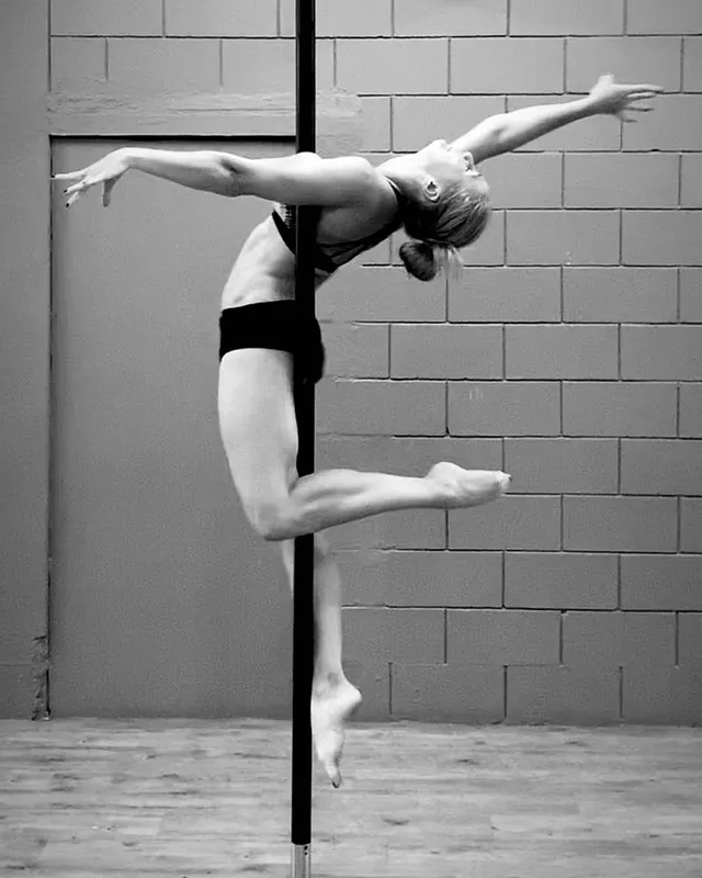 Artistic hooded pole performance pose